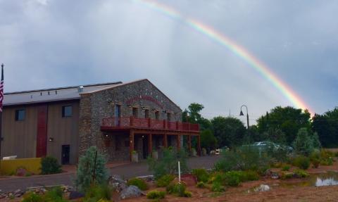 Camp Verde Community Library building with rainbow in the sky over it